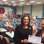 A view of the club and staff with their Bingo Association big cheque.