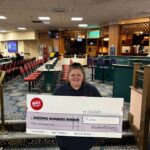 A big money winner shows off her big cheque at the Northampton Buzz Bingo.