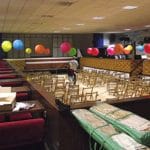 The hall, from having entered through the second set of doors. The bingo tables have been kept round the sides, but the tables in the middle have been removed. The seats that you see in the photo are for the audience for a show; a group from the nearby Maltings arts centre were using the hall for a show that weekend, and were setting it up the day I visited!