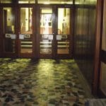 The foyer area, with the doors leading into the circulating area ahead. On the left, is the book sales/membership enquiries desk.
