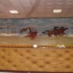 Some of the décor on the walls. The chariots on the walls are raised off the surface, and are original. The other artwork you see here was recently done, and I have to say suits it well. Some of the glass or mirrors in the hall also had chariots on them.