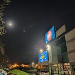 All lit up, a night time view of the exterior of the club.