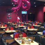 A view of seating and a table set up for a 98th birthday party.