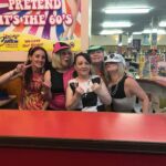 Staff on book sales dressed up for 1960s night.