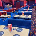 Empty tables with their Covid reopening safety seating stickers.