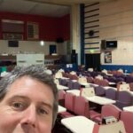 A staff member poses in front of the tables at the club.